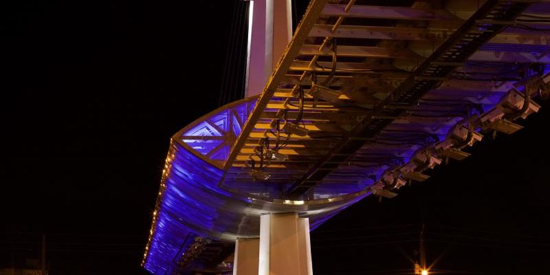Blue LED lighting illuminates a toll gantry in Florida