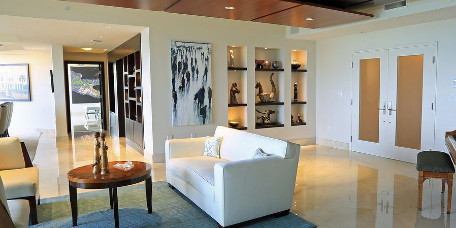 Downlights accent artwork on shelves in a living room