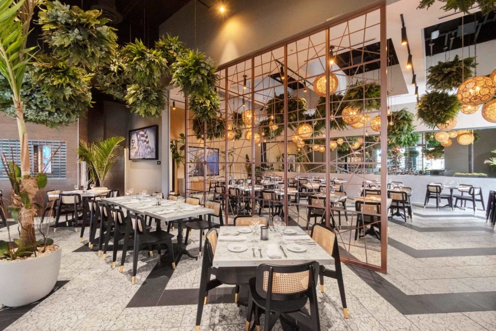 Warm, decorative pendant lighting at The Estefan Kitchen Restaurants